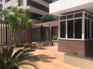 a courtyard of a building with a fence at Homestay Fortaleza in Fortaleza