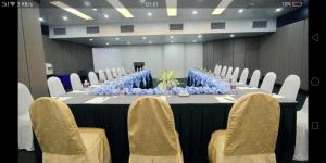 a long table with chairs and blue flowers on it at GloRy BeAch ResOrt private apartment in Port Dickson +61 photos