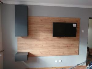 a flat screen tv mounted on a wall at Apartament Alena in Baile Felix