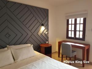 En eller flere senge i et værelse på Hotel Valledupar Plaza