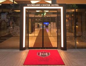 a red rug in front of a door of a building at Izumisano Center Hotel Kansai International Airport in Izumi-Sano