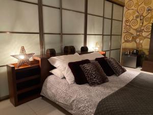 a bedroom with a bed with pillows and a star at Sliema La Loggia Suites in Sliema