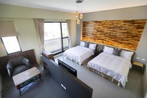 Rúm í herbergi á 東立方旅宿-East Cube B&B