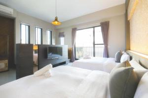 Rúm í herbergi á 東立方旅宿-East Cube B&B
