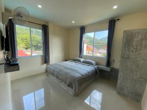 Postel nebo postele na pokoji v ubytování Budchui Guesthouse