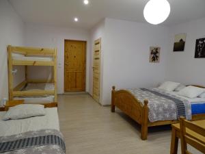 a bedroom with two beds and a bunk bed at Romanówka in Ołdrzychowice Kłodzkie