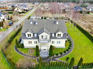 an aerial view of a large white house at Villa Antoja in Grzybowo