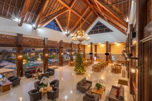 a lobby with a christmas tree in the center at The Salila Beach Resort in Seminyak