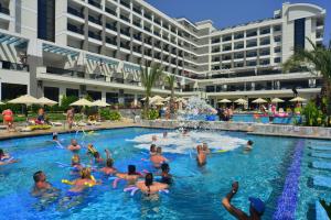 een groep mensen in het zwembad van een hotel bij Seaden Valentine Resort & Spa Adults Only in Side