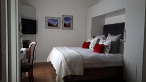 a bedroom with a large bed with red pillows at Turbine Hotel & Spa in Knysna