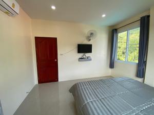 Postel nebo postele na pokoji v ubytování Budchui Guesthouse