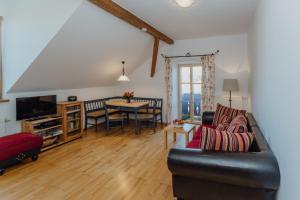 a living room with a couch and a table at Bernwieserhof in Bad Heilbrunn