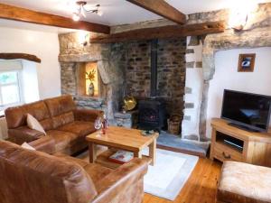 a living room with a couch and a fireplace at The Stables in Settle