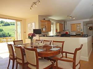 a kitchen and dining room with a table and chairs at Fairview House in Dartmouth