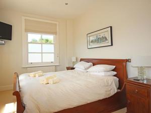 a bedroom with a bed with two towels on it at Fairview House in Dartmouth