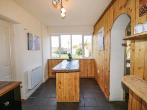 a kitchen with a wooden counter and a window at Barforth Hall Lodge in Richmond