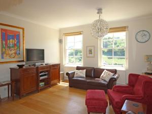 a living room with a couch and a tv at Fairview House in Dartmouth