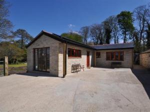 a house with a large patio in front of it at Follis Cottage in Weymouth