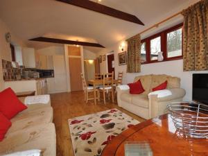 a living room with a couch and a table at Follis Cottage in Weymouth