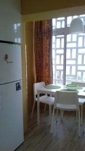 a kitchen with a table and chairs and a refrigerator at Pénareia in Peniche