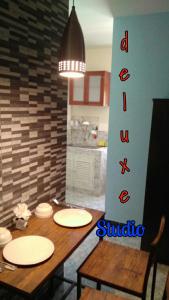 a dining room with a table with white plates on it at Studio with aircon n kitchen in Bang Tao Beach