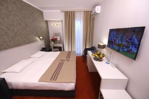 A bed or beds in a room at Zepter Hotel Vrnjacka Banja, member of Zepter Hotels