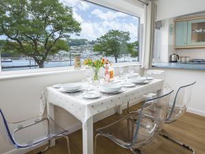 a white table and chairs in a kitchen with a window at Leeside in Dartmouth
