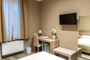 a hotel room with a desk and a bed at Delight Rooms in Corbetta