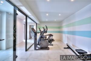 a gym with treadmills and ellipticals in a room at Domaine du Peyrouas in Saint-Jeannet