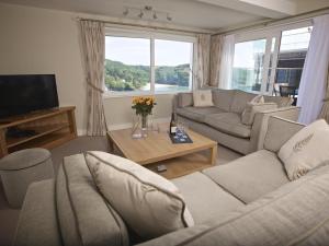 a living room with two couches and a television at 2 Hamstone Court in Salcombe