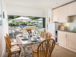 a kitchen and dining room with a table and chairs at Prospects in Salcombe