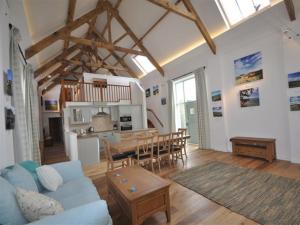 a living room with a blue couch and a table at Leys At Valley View Farm in Lyme Regis