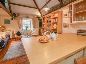 a kitchen with a counter with a bowl of food on it at Lee Shore in Salcombe