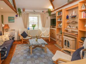 a living room with a couch and a fireplace at Lee Shore in Salcombe