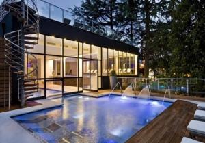 a house with a swimming pool in front of a building at Sentirsi a Casa in Boario Terme