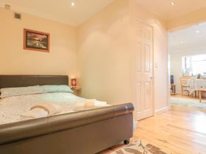 a bedroom with a bed and a dining room at Church Road Annexe in Cinderford