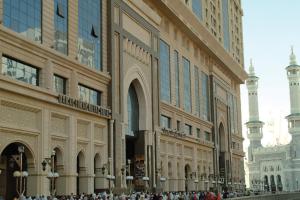 a group of people standing in front of a building at Dorrar Al Eiman Royal Hotel in Mecca