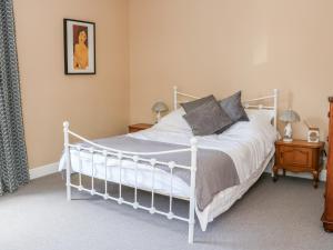 a bedroom with a white bed in a room at West View Cottage in Settle