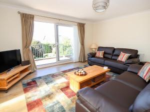 a living room with a couch and a coffee table at Cesail Y Mynydd in Rhyl