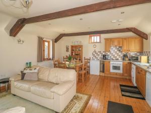 ein Wohnzimmer mit einem Sofa und einer Küche in der Unterkunft Swallows Nest in Launceston