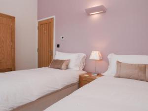 מיטה או מיטות בחדר ב-Quay Lodge
