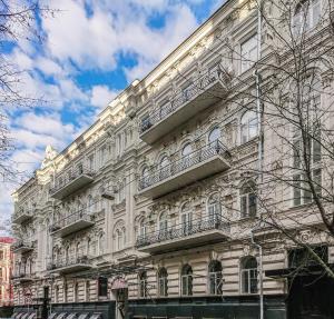 a large building with balconies on the side of it at Globe Runner Rooms & Dorms in Kyiv