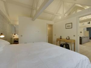 a bedroom with a large white bed in a room at Hayloft in Talaton