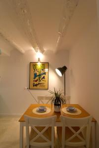 une salle à manger avec une table, des chaises et une lampe dans l'établissement Apartamento l'Illot, à L'Ametlla de Mar