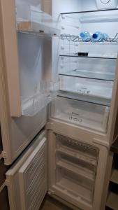 an empty refrigerator with its door open in a kitchen at Apartament Fibra Frappe in Rybnik