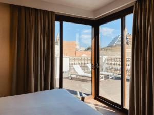 a window with a view of a city at Hotel Unuk in Seville