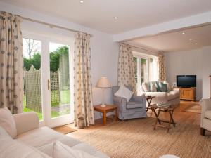 uma sala de estar com um sofá e uma cadeira em Homefield House em Thurlestone