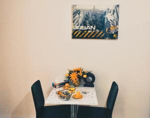 a table with chairs and a plate of food on it at Chez Sophie - Part Die in Lyon