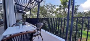 a porch with a white table and chairs on a balcony at Girasol Tagaytay in Tagaytay