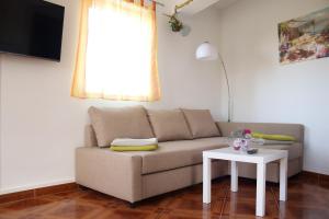 a living room with a couch and a table at Apartments Pegla in Nerezine